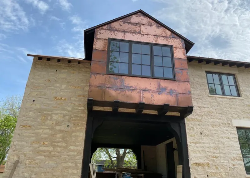 Copper metal panel facade on a stone building for Skylight Installation in Deltona